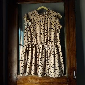 Taupe colored frilly top with a cinched elastic waist